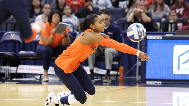 Milan Gomillion digs a ball during the Virginia volleyball match against Virginia Tech at John Paul Jones Arena.